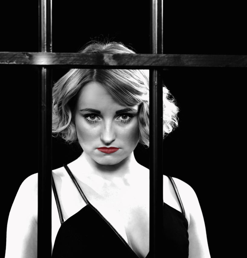 female actress behind bars in the musical Chicago