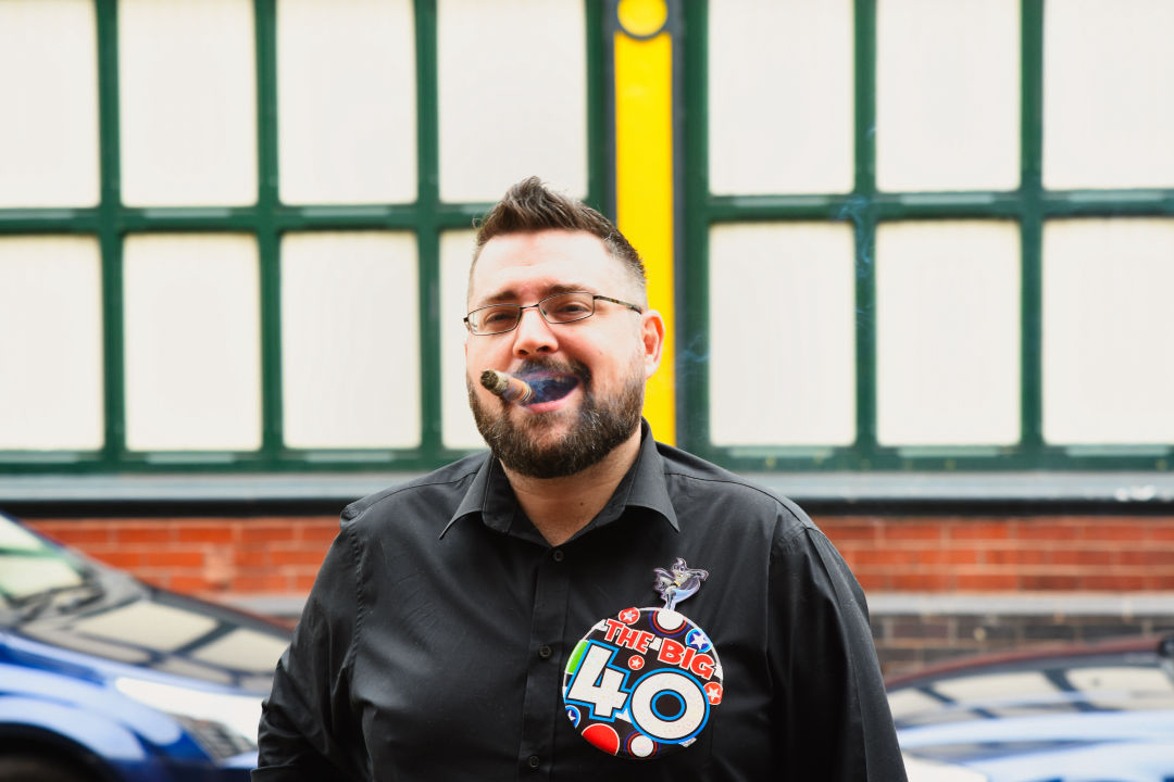 A Man celebrating his 40th with a big fat cigar