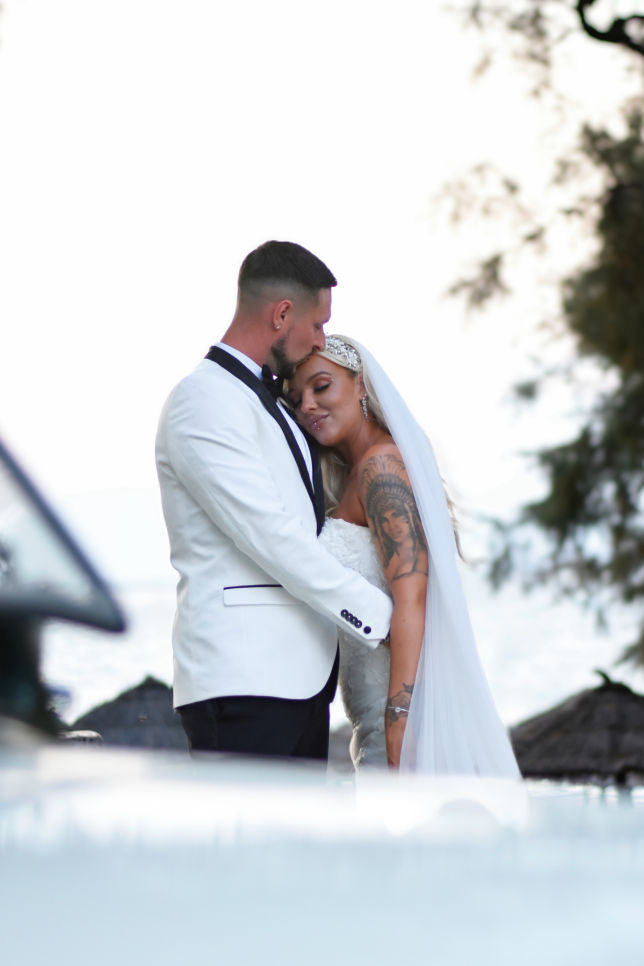 bride and groom near their wedding car 