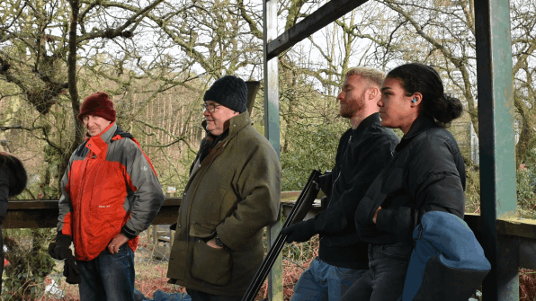 A group of clients having a go at clay pigeon shooting on a corporate day in Manchester   